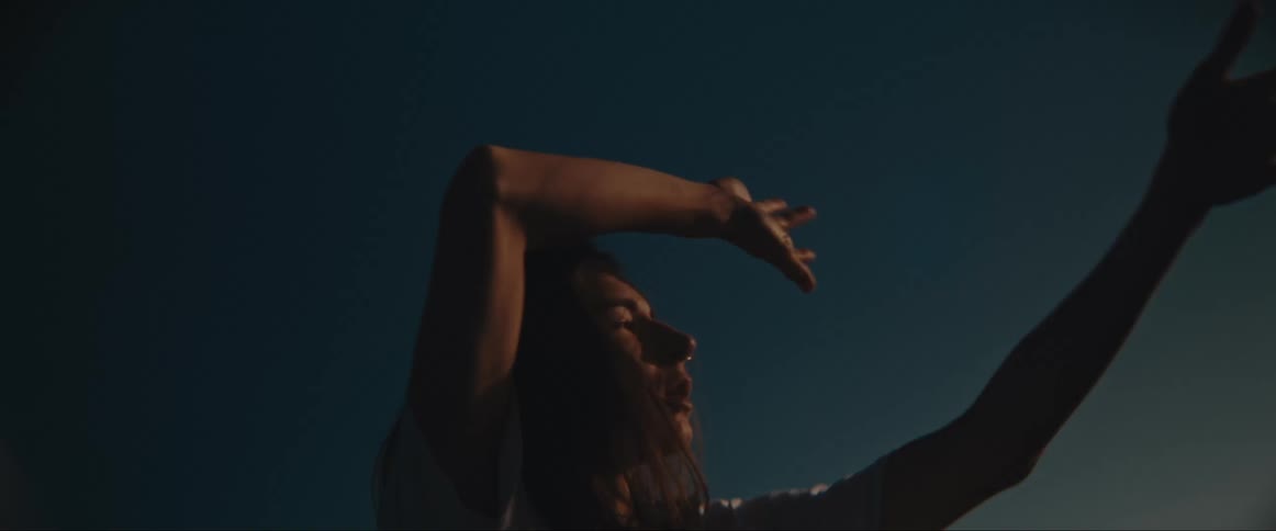 A woman dances at sunrise