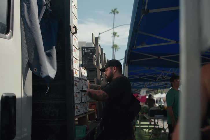 Man delivering groceries from a truck to the market