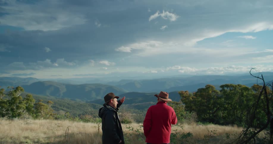 Two men talking in a meadow during the day