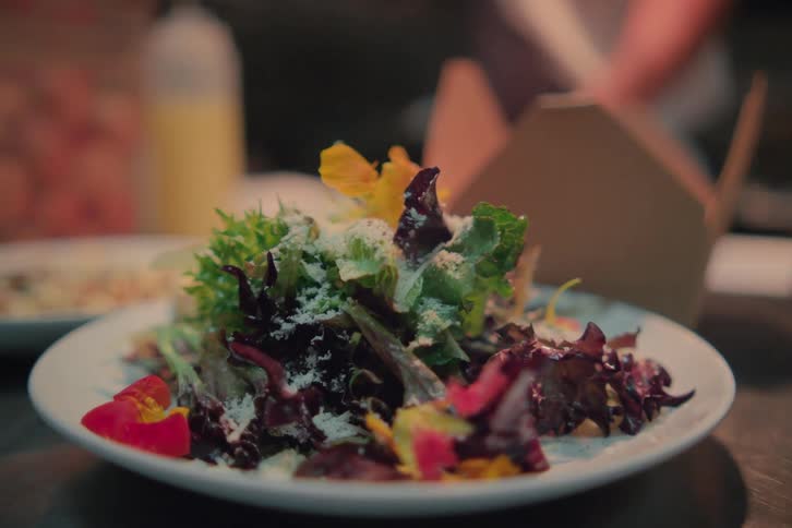 A white plate full of salads and vegetables