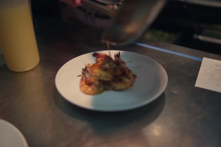 A man is serving food in the restaurant