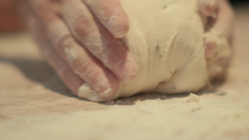 A clip of a person making a flour dough