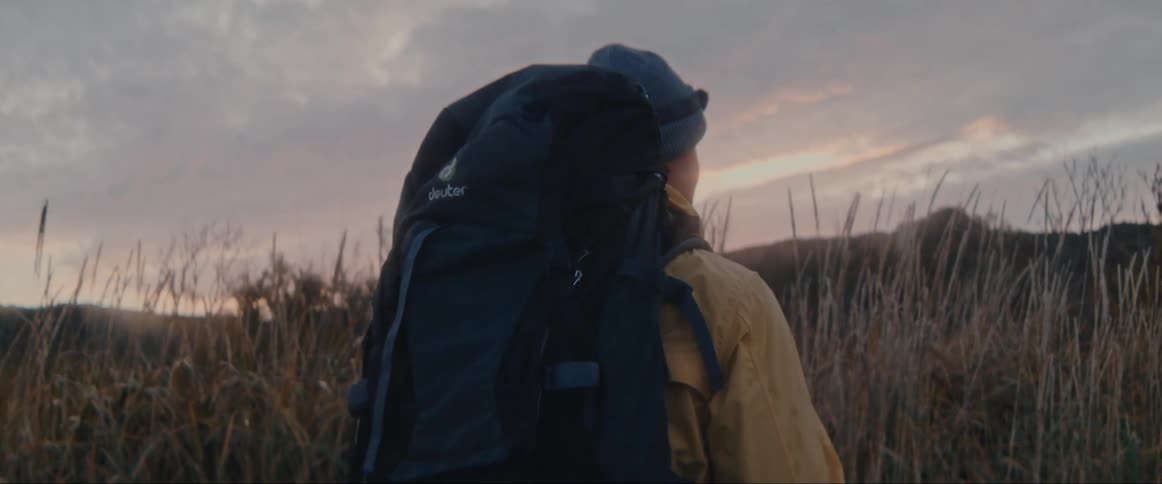 A woman is hiking at dawn