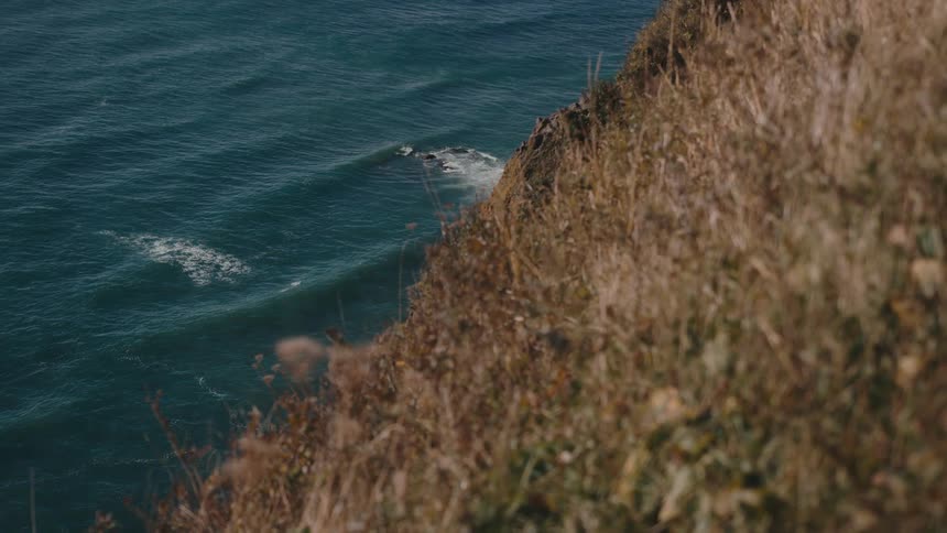 The waves move down by the bottom of the hill