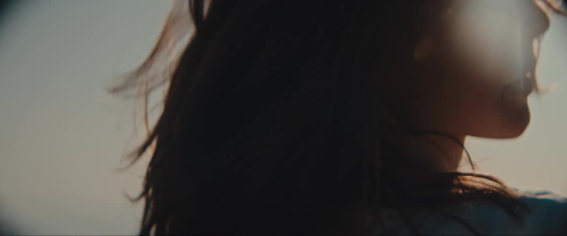 A woman is smiling and moving excitedly with her eyes closed