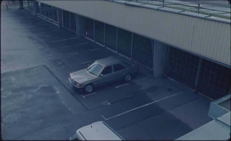 Car parked on a parking lot caught on vintage film
