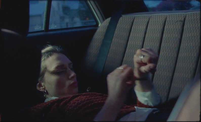 Woman resting on the backseat of a car