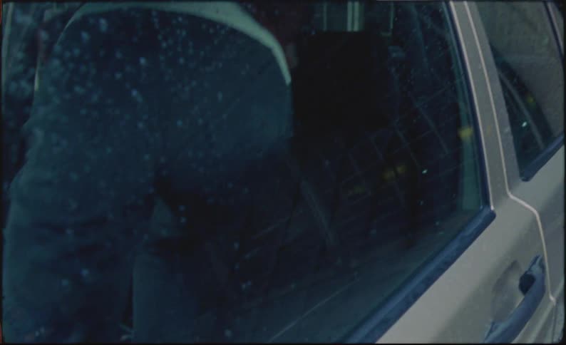 Sad woman crying in her car on a rainy day