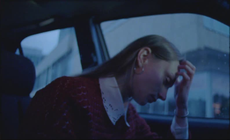 A lady in her car looking sad