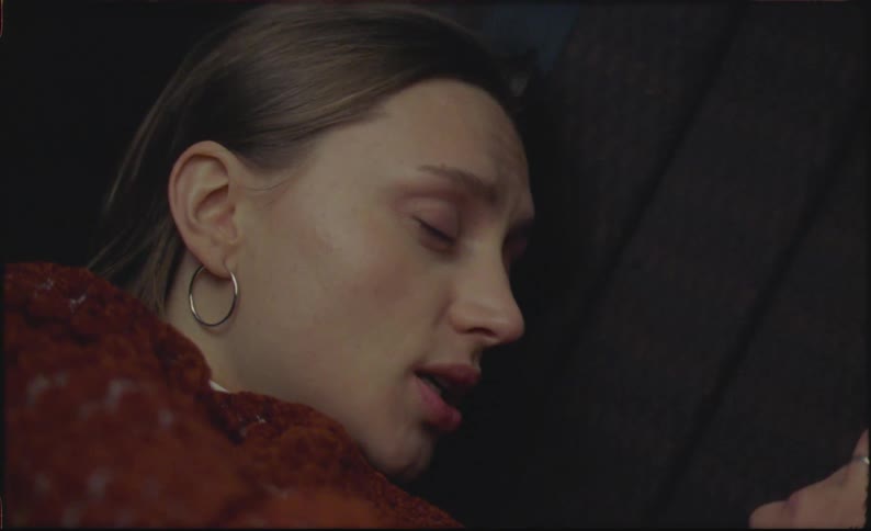 Close up of a young woman talking to herself inside a car