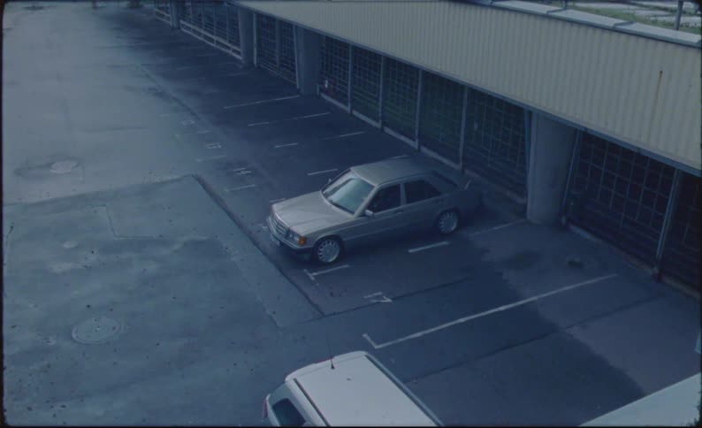 Older model vehicles parked in a parking lot outdoors