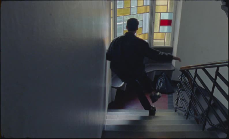 A teenager sits on the staircase