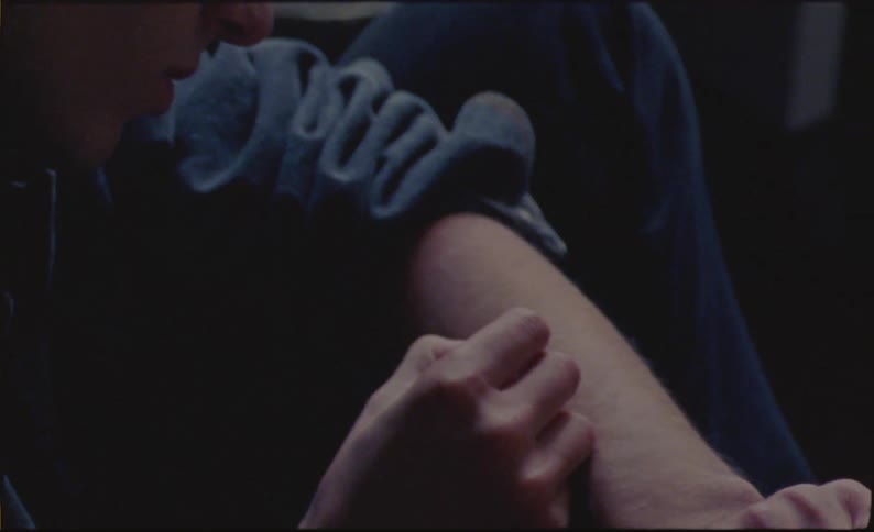 Close up of a young man writing on his forearm