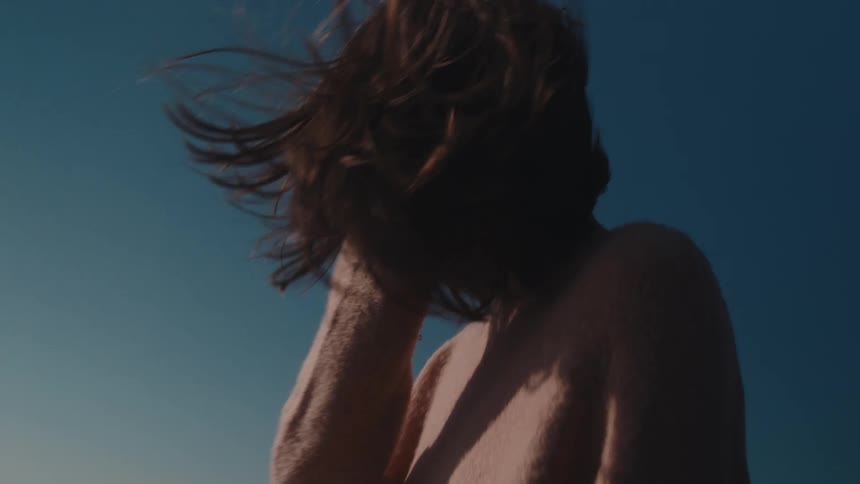 A woman on the beach contemplating the sea