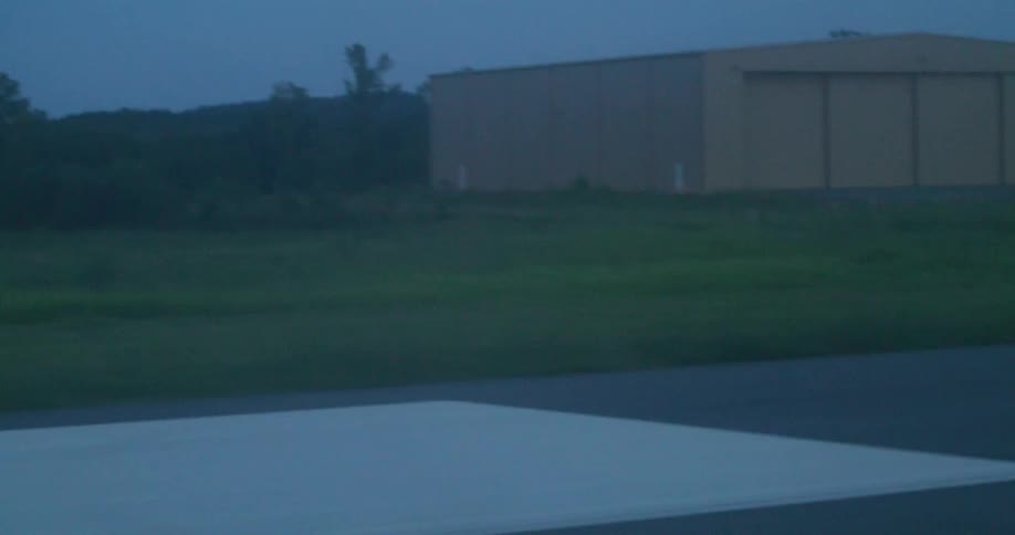 Tarmac of a runway seen from a small airplane taking off at morning