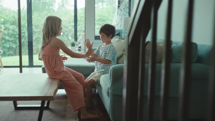 A boy and girl playing games in a house together