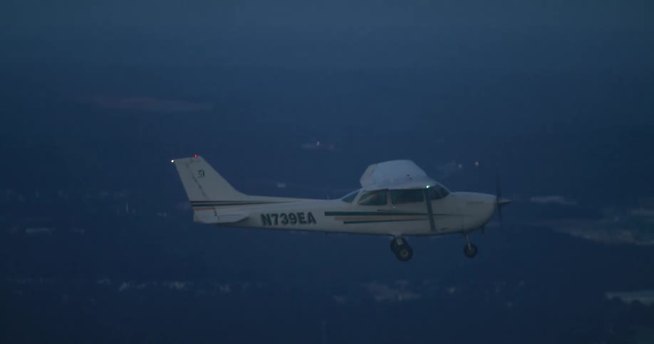 The plane is flying high in the sky