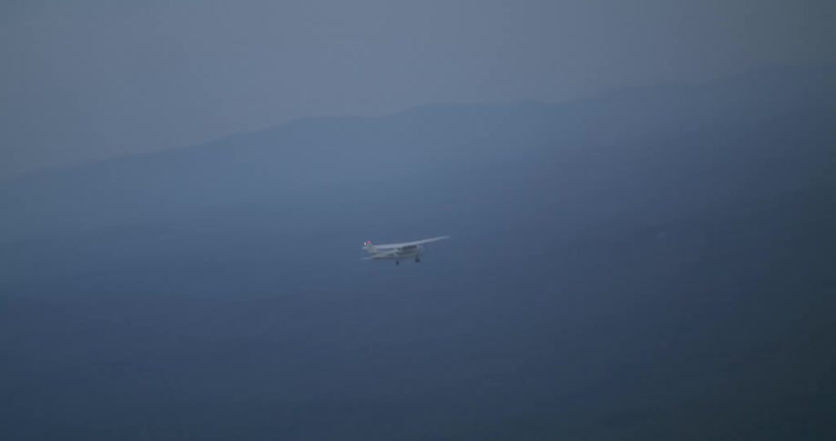 Small airplane flies at dusk