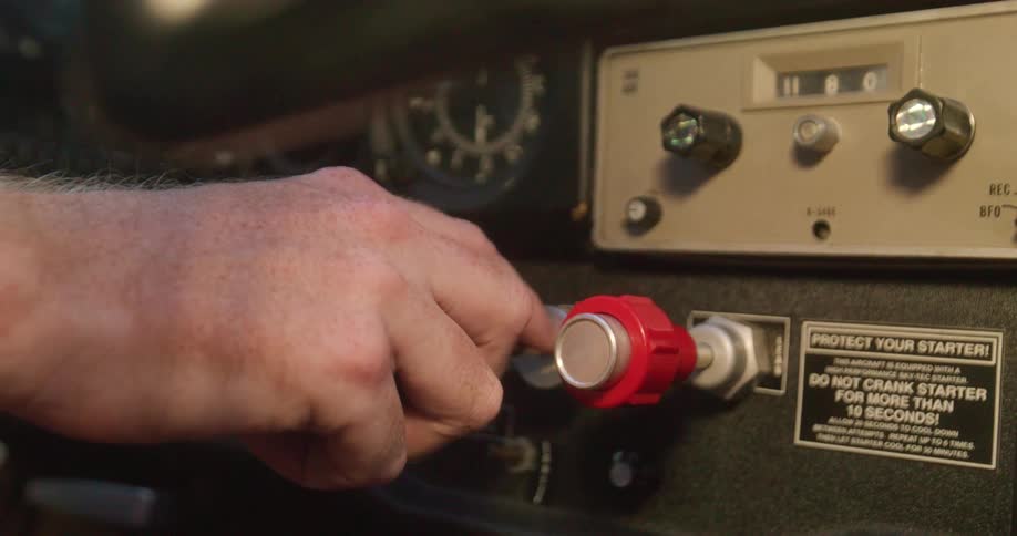 Hand reaches for knob on dashboard