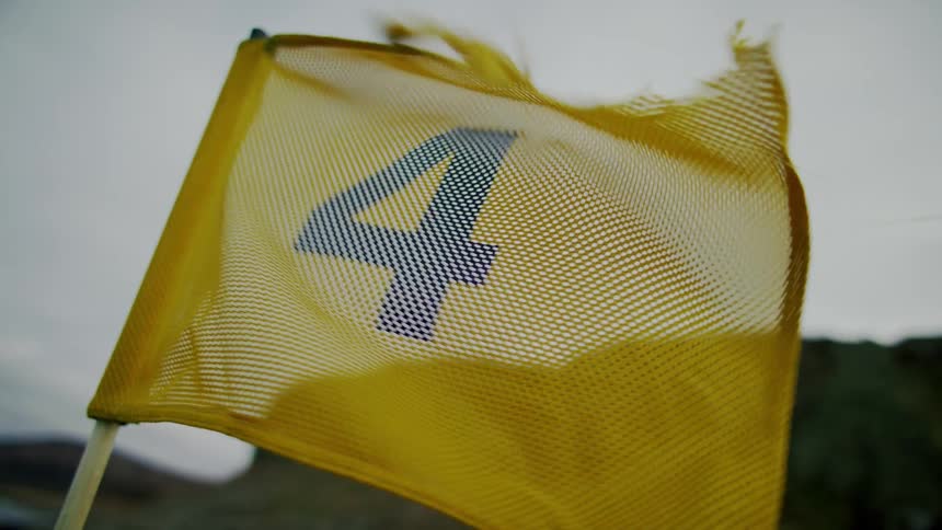 A flag blowing outdoors on a cloudy day