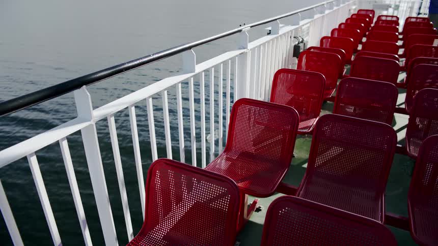 Close up of red chairs on the deck of a ferry