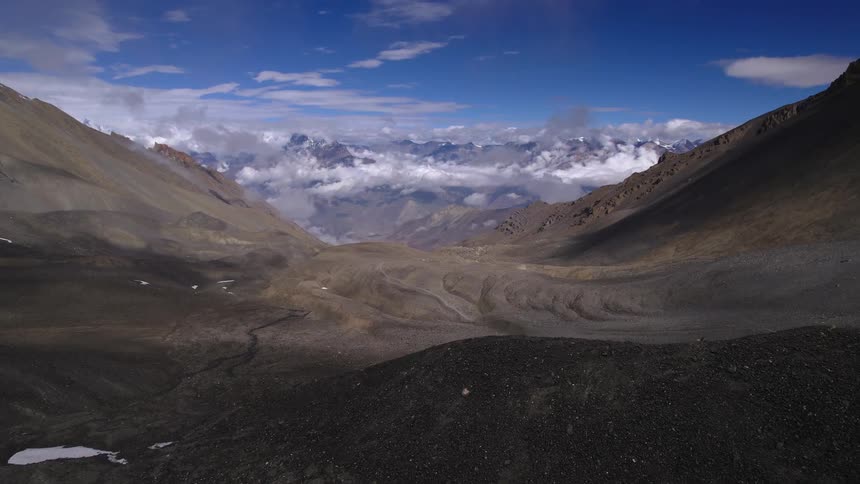 Aerial view of mountain region with snowy mountains on the background