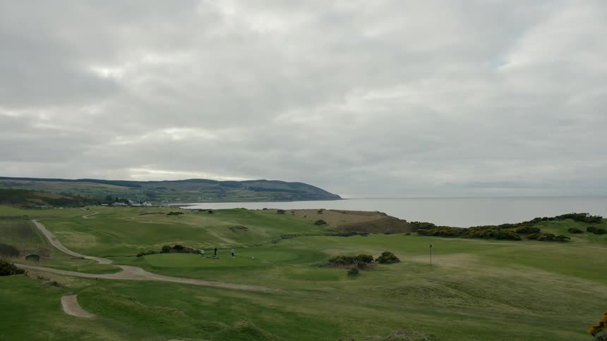 A view of some grasslands and a lake in the distance