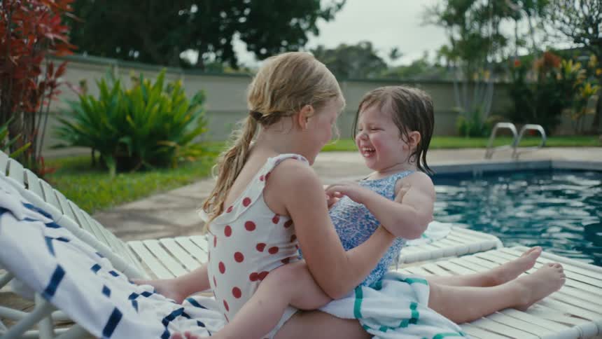 Two children play by the pool