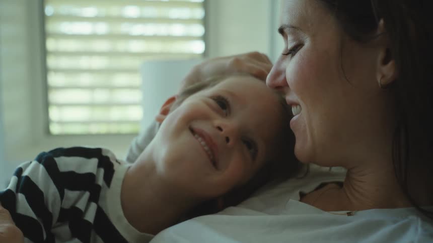 Mother and son resting in the bedroom talking