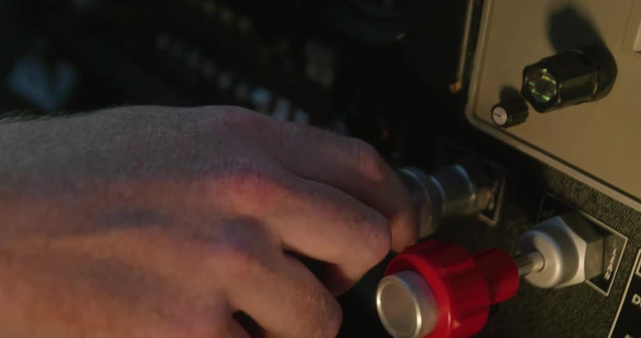 Close up of a hand pulling a knob in a dashboard