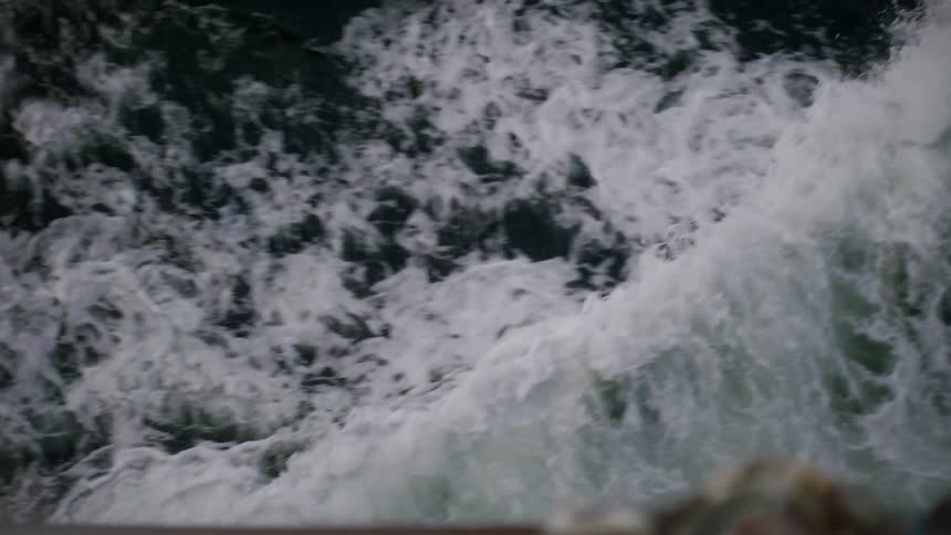 An aerial view of waves crashing in the ocean
