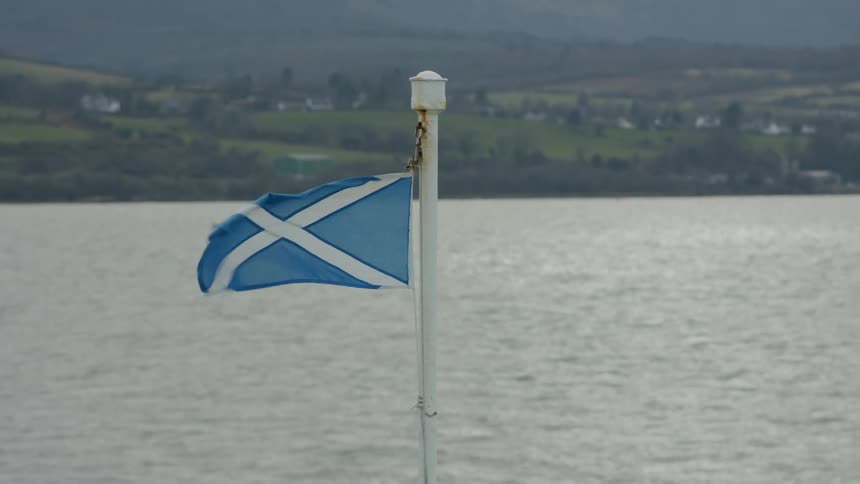 A flag on a pole outdoors on a sunny day