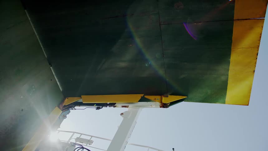 The water reflects on the boat roof
