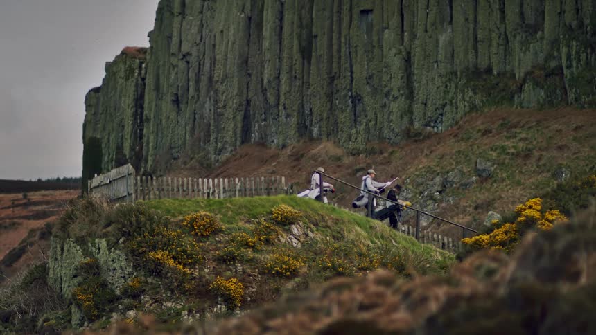 People walking down a staircase on a golf course