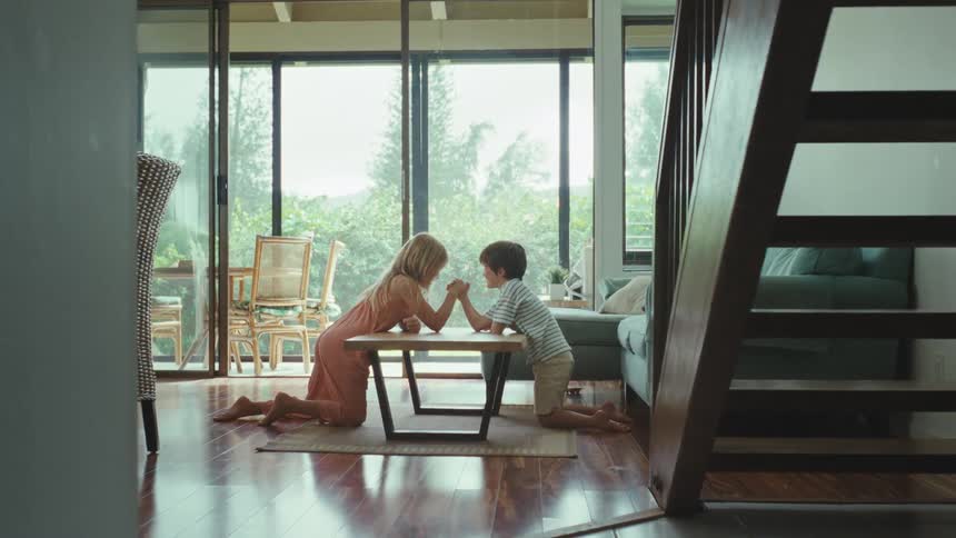 Kids playing a test your might game in the living room