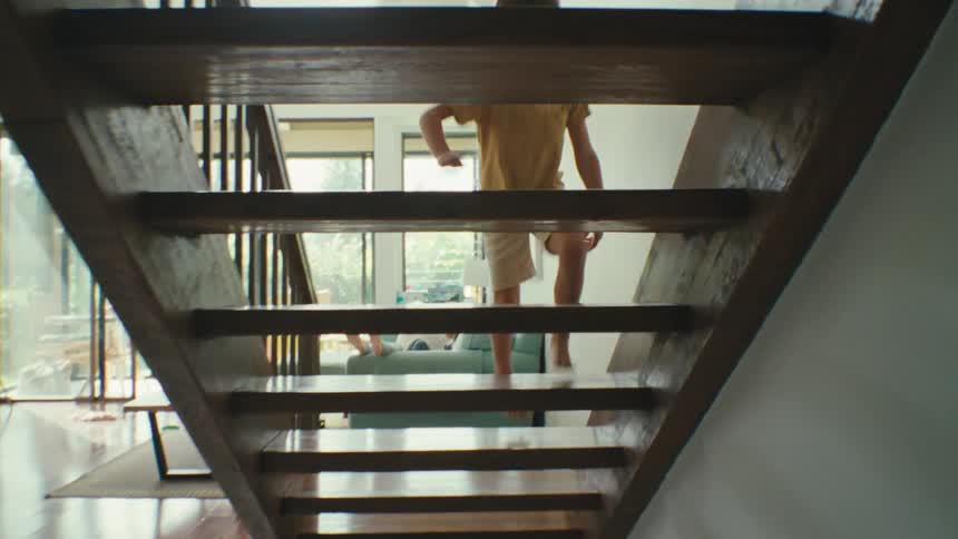 A child runs up the stairs