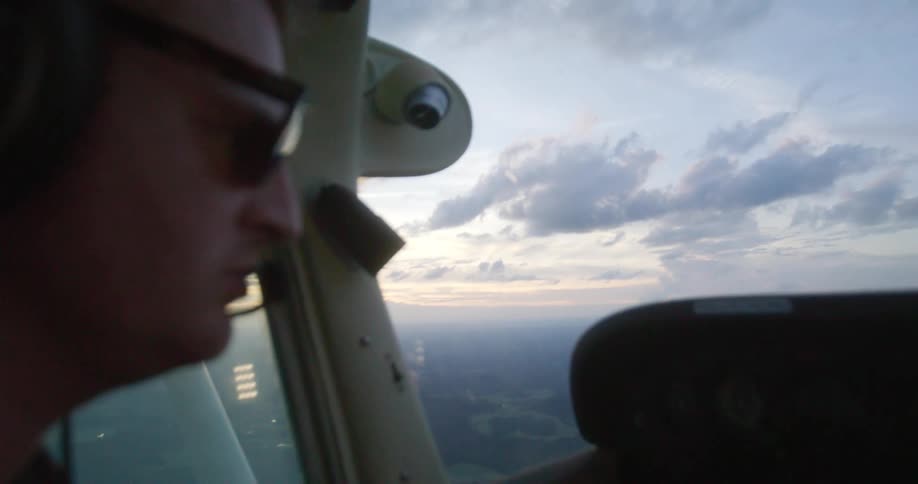 Close up of a man flying a plane outdoors