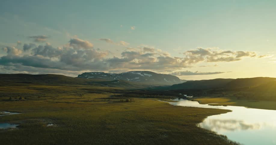 A stream runs through the landscape to the mountains
