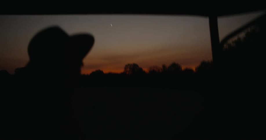 Silhouette of a woman on a safari through the african savanna at sunset