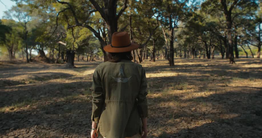 A woman is hiking in the woods