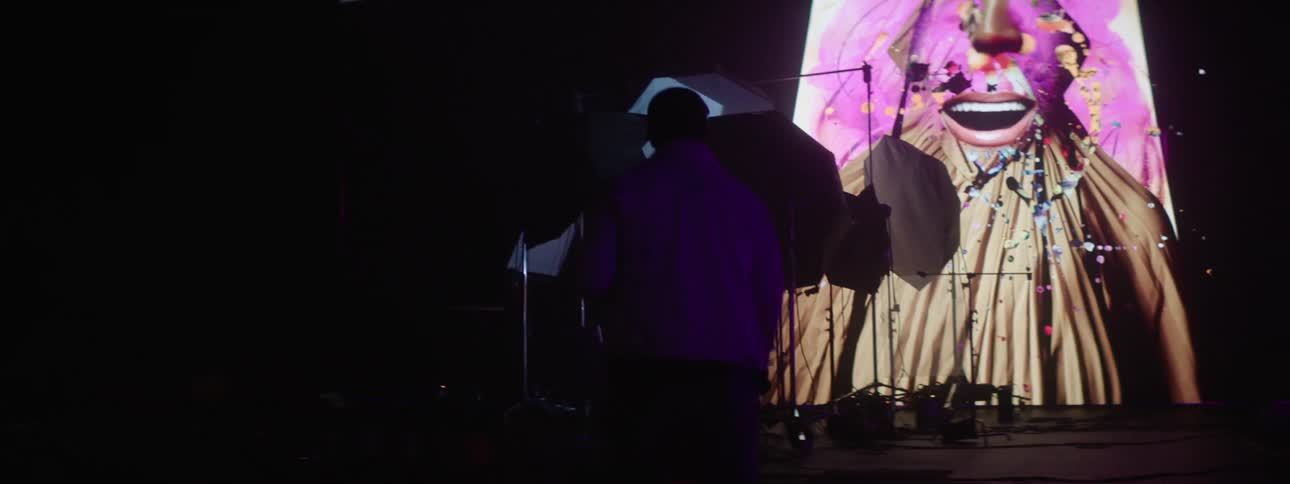A clip of a man entering into the studio