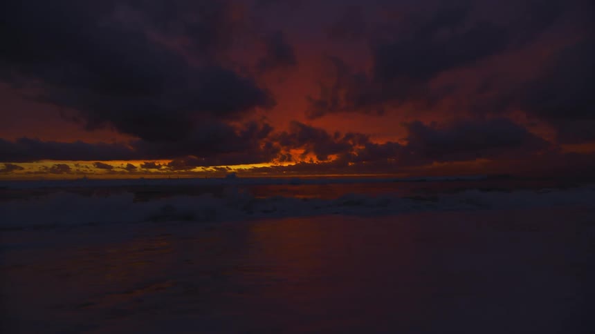 Beautiful scene of ocean waves washing in the coast at sunset