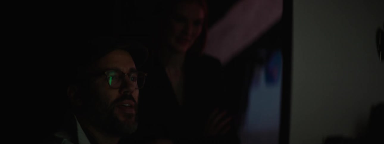 A man and woman are looking at the computer