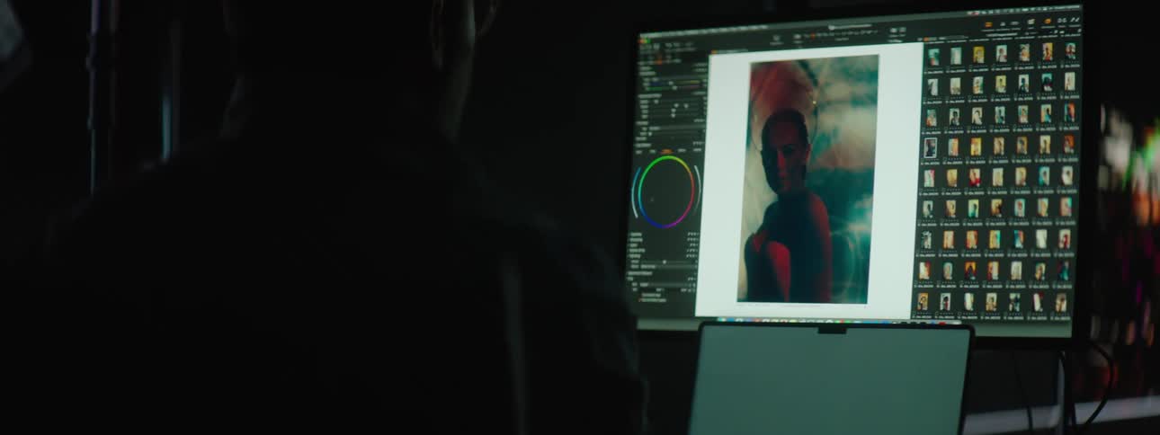 A photographer editing pictures on a computer