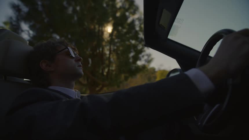 A man presses his head against the steering wheel