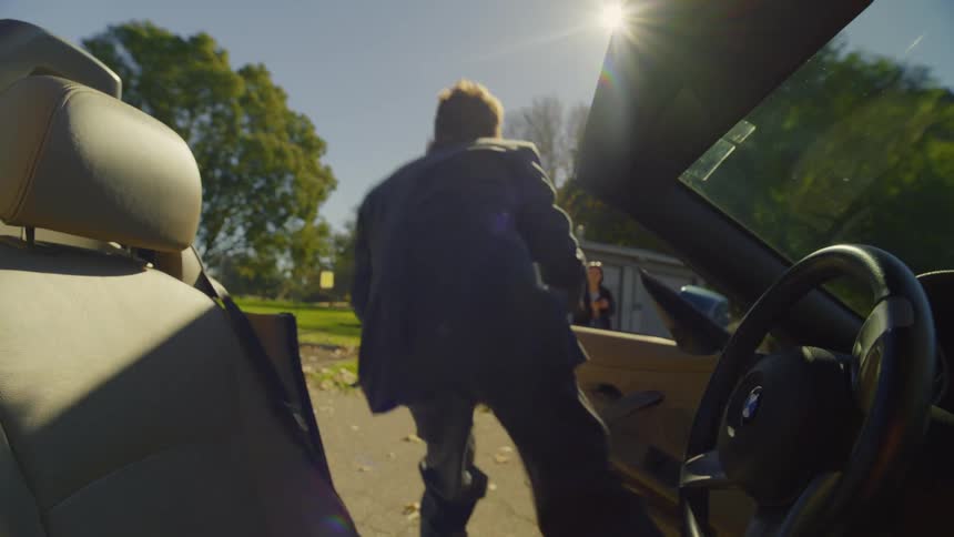 A man gets out of the car