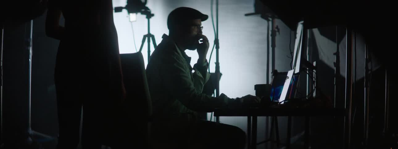 A clip of a studio photographer making an illustration to a studio model