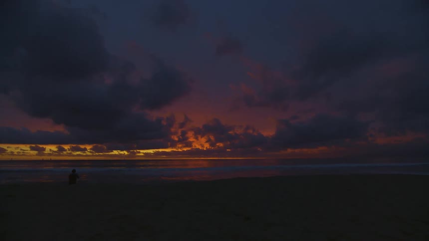 Shoreline of a beach at sunset