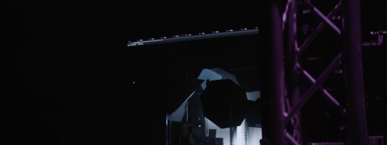 A stage with lots of electronic and a display screen