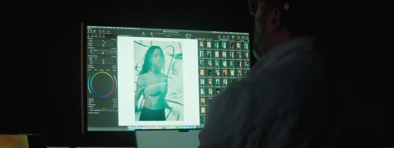A man is looking at photos on his computer